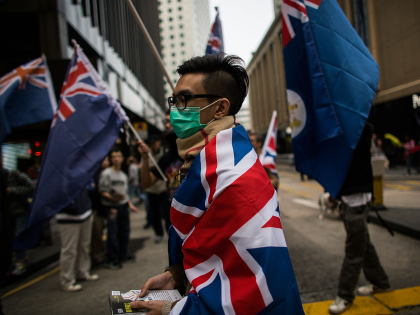 HONG KONG - FEBRUARY 01: A pro-democracy protester wears a Union Jack during a march for d