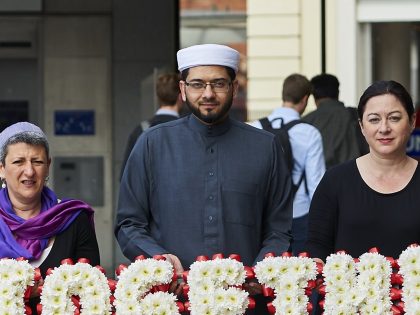 Faith leaders pose for pictures during an event to promote religious unity in central London on July 6, 2015, as Britain prepares to mark the ten year anniversary of the 7/7 London bombings in which 52 people were killed. (From L-R) Rabbi Laura Janner-Klausner, Imam Qari Asim, 7/7 survivor Gill …