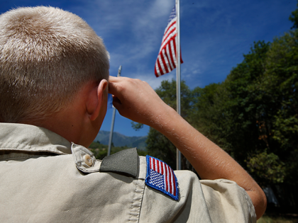 A Boy Scout salutes the American flag at camp Maple Dell on July 31, 2015 outside Payson,