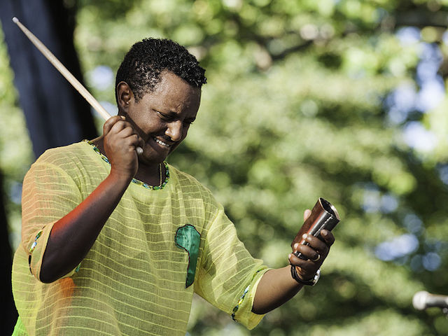 Ethiopian musician Teddy Afro (born Tewodros Kassahun) plays a cow bell as he performs on stage as he headlines an afternoon of African music at Central Park SummerStage, New York, New York, July 5, 2014. (Photo by Jack Vartoogian/Getty Images)