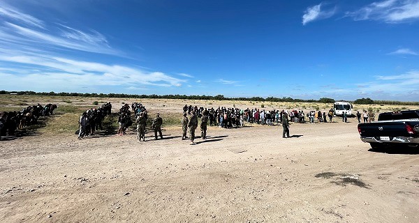 A lone Border Patrol agent organizes a 400+ migrant group by nationality on Father's Day near Normandy, Texas. (Randy Clark/Breitbart Texas)