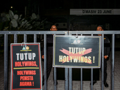 This picture taken on June 24, 2022 shows placards reading "shut down Holywings" and "blasphemy Holywings" put up by members of an Islamic organisation in front of the Holywings bar in Jakarta. - Indonesian police arrested six people on charges of blasphemy over a bar chain's free alcohol promotion for …
