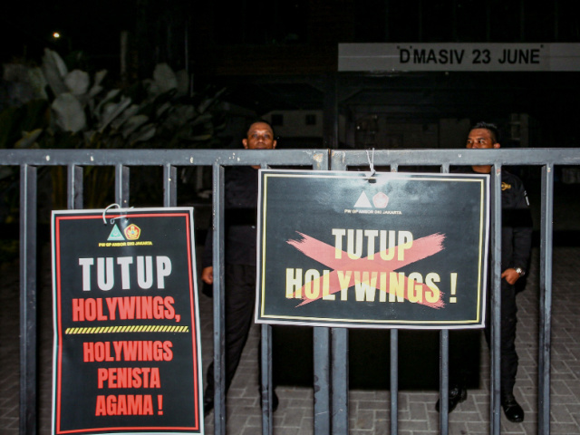 This picture taken on June 24, 2022 shows placards reading "shut down Holywings"