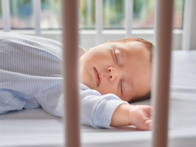 Infant sleeping in a crib