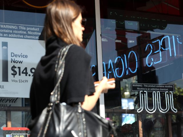 SAN FRANCISCO, CALIFORNIA - OCTOBER 17: A pedestrian walks by a window advertisement for Juul products on October 17, 2019 in San Francisco, California. Juul announced plans to immediately suspend sales of its fruit flavored e-cigarettes ahead of a policy by the Trump administration that is expected to ban all …