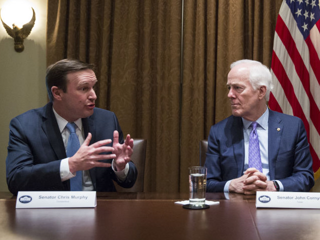 Senator Chris Murphy, a Democrat from Connecticut, from left, speaks as Senate Majority Whip John Cornyn, a Republican from Texas, and U.S. President Donald Trump listen during a meeting with bipartisan members of Congress to discuss school and community safety in the Cabinet Room of the White House in Washington, D.C., U.S. on Wednesday, Feb. 28, 2018. Trump has vowed to pass new laws designed to curb campus gun violence following the Feb. 14 shooting at a Parkland, Florida high school in which 17 people were killed and more than a dozen more wounded. Photographer: Joshua Roberts/Bloomberg
