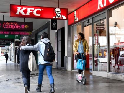 A person walks past a KFC outlet in Melbourne's central business district on July 15, 2020. Australians under lockdown for the second time are struggling with fresh virus restrictions, with police saying on July 15 they had dished out hundreds of fines including to people playing Pokemon Go and eating …