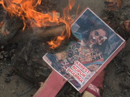KOLKATA, INDIA - JUNE 10: Members of the Muslims community burn an image of now suspended BJP spokesperson Nupur Sharma during a protest against the comments made by her on Prophet Muhammad, at Park Circus Seven points crossing on June 10, 2022 in Kolkata, India. Protests erupted in several parts …