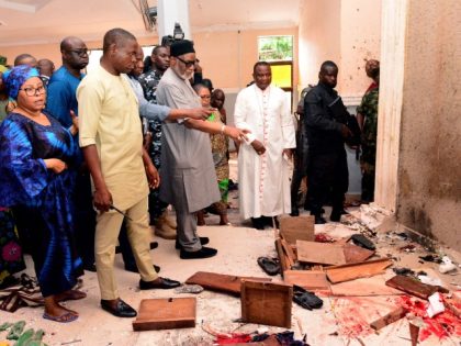 EDITORS NOTE: Graphic content / TOPSHOT - Ondo State governor Rotimi Akeredolu (3rd L) points to blood the stained floor after an attack by gunmen at St. Francis Catholic Church in Owo town, southwest Nigeria on June 5, 2022. - Gunmen with explosives stormed a Catholic church and opened fire …