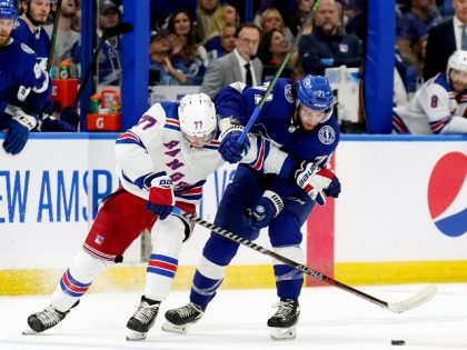 New York Rangers center Frank Vatrano (77) and Tampa Bay Lightning center Anthony Cirelli, right, battle for possession of the puck during the second period in Game 4 of the NHL Hockey Stanley Cup playoffs Eastern Conference finals Tuesday, June 7, 2022, in Tampa, Fla. (AP Photo/Chris O'Meara)