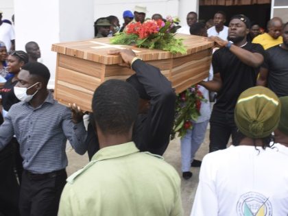 Mourners carry a coffin of one of the victims killed at the St. Francis Catholic Church on June 5, during a funeral service in Owo, Southwest of Nigeria, Friday, June 17, 2022. Nigeria held a state funeral Friday for nearly two dozen of the worshippers killed by gunmen at a …