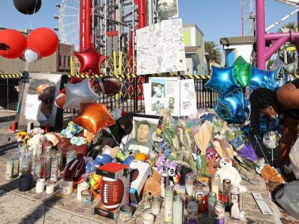 Family members and friends of Tyre Sampson leave flowers and other items at a vigil in front of the Orlando Free Fall drop tower in ICON Park in Orlando, Florida, on March 28, 2022. Sampson, 14, was killed when he fell from the ride. (Stephen M. Dowell/Orlando Sentinel/Tribune News Service …