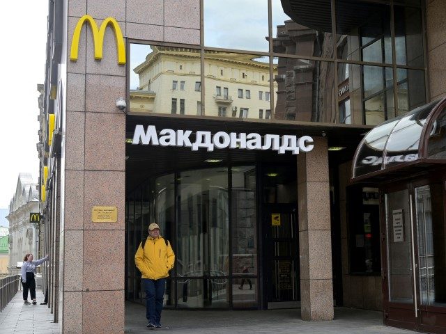 A man walks past a closed McDonald's restaurant in Moscow on May 16, 2022. - American fast