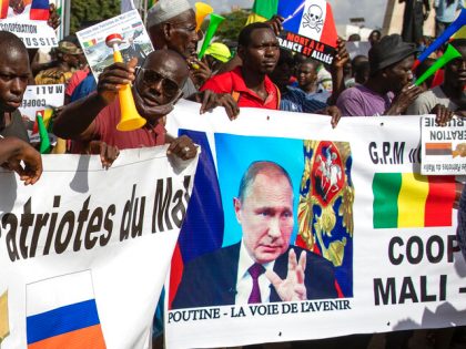 FILE - Malians demonstrate against France and in support of Russia on the 60th anniversary of the independence of the Republic of Mali in 1960, in Bamako, Mali, Sept. 22, 2020. The banner in French reads: "Putin, the road to the future". Russia has engaged in under-the-radar military operations in …