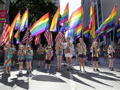 Scouts carrying rainbow and American flags prepare to march in the 45th annual Seattle Pride Parade Sunday, June 30, 2019, in Seattle. The parade commemorated both the first "gay liberation week" in 1974 and the 50th anniversary of the Stonewall uprising, a police raid that sparked the modern-day gay rights …
