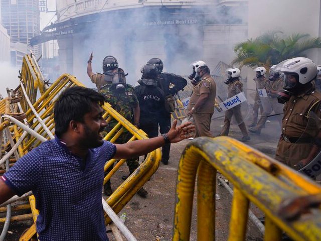 Police fire tear gas to disperse anti-government protesters who made an attempt to enter the police headquarters during a protest in Colombo, Sri Lanka, Thursday, June 9, 2022. (AP Photo/Eranga Jayawardena)