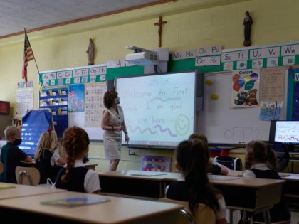 First grade students at a Catholic elementary school on the first day of classes in Boston, Massachusetts, on Tuesday, Sept. 7, 2021. Students are returning to in-person learning despite the Bay State seeing a rise in coronavirus cases. (Allison Dinner/Bloomberg via Getty Images)