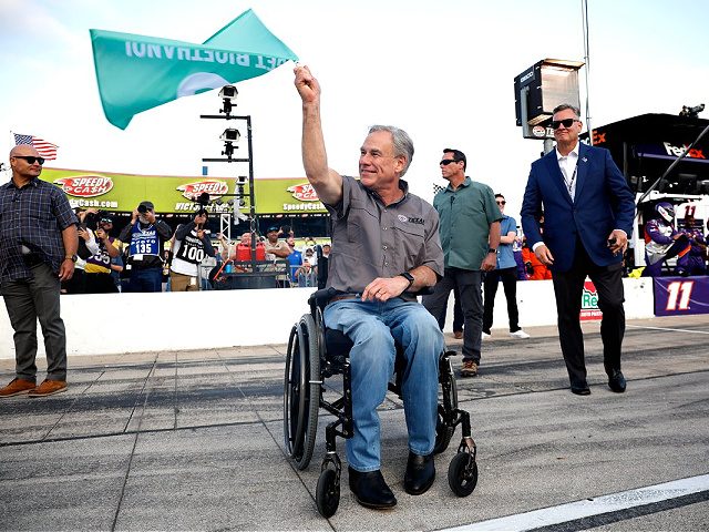 FORT WORTH, TEXAS - MAY 22: Greg Abbott, governor of Texas waves the green flag to start the NASCAR Cup Series All-Star Race at Texas Motor Speedway on May 22, 2022 in Fort Worth, Texas. (Photo by Chris Graythen/Getty Images)