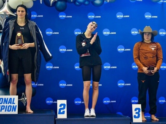 transgender athletes ATLANTA, GA - MARCH 17: University of Pennsylvania swimmer Lia Thomas accepts the winning trophy for the 500 Freestyle finals as second place finisher Emma Weyant and third place finisher Erica Sullivan watch during the NCAA Swimming and Diving Championships on March 17th, 2022 at the McAuley Aquatic …