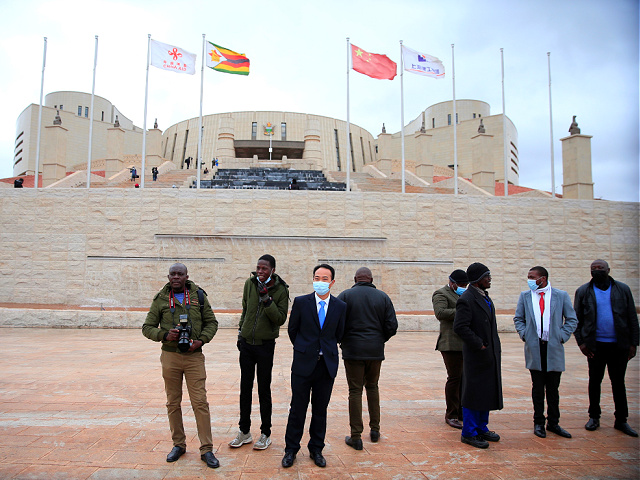 People communicate in front of Zimbabwe's new parliament building on Mount Hampden Hill in Zimbabwe on June 29, 2022.  Zimbabwe's new parliament building, built by China as a gift to the South African country and fully funded, is now complete and ready for occupation.  (Shawn Jusa / Xinhua photo via Getty Images)