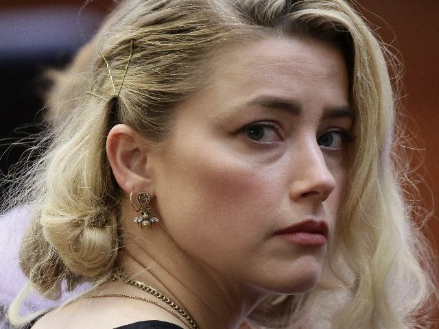 TOPSHOT - Actor Amber Heard waits before the jury said that they believe she defamed ex-husband Johnny Depp while announcing split verdicts in favor of both her ex-husband Johnny Depp and Heard on their claim and counter-claim in the Depp v. Heard civil defamation trial at the Fairfax County Circuit …