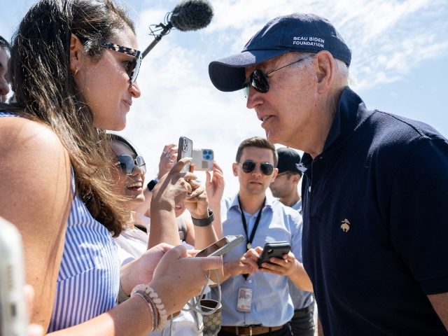 US President Joe Biden speaks with reporters as he walks on the beach in Rehoboth Beach, Delaware, June 20, 2022. (Photo by SAUL LOEB/AFP via Getty Images)