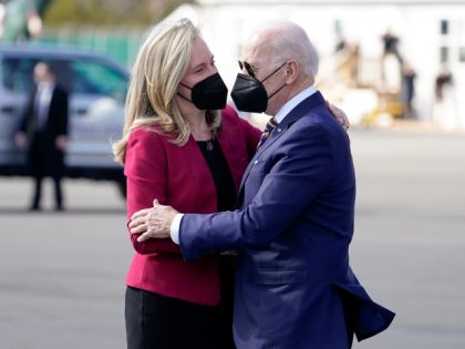 President Joe Biden hugs Rep. Abigail Spanberger, D-Va., as he arrives on Marine One at Culpeper Regional Airport, Thursday, Feb. 10, 2022, in Brandy Station, Va. (AP Photo/Alex Brandon)