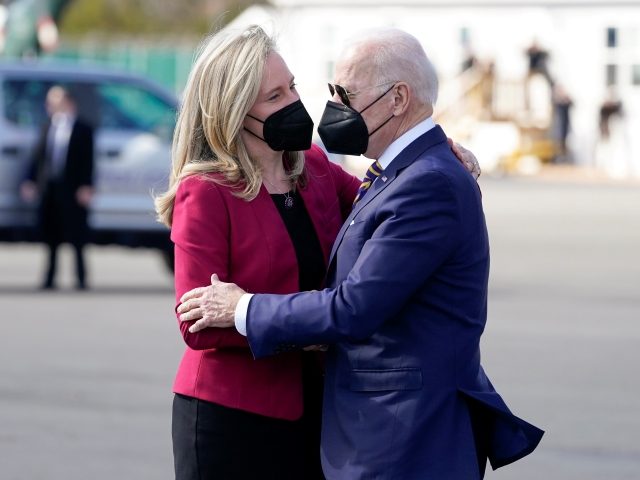 President Joe Biden hugs Rep. Abigail Spanberger, D-Va., as he arrives on Marine One at Cu