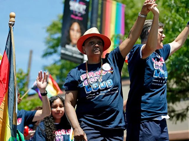 Chicago Mayor Lori Lightfoot, left, and her wife, Amy Eshleman, participate in the 51st Chicago Pride Parade in Chicago, Sunday, June 26, 2022. (AP Photo/Jon Durr)