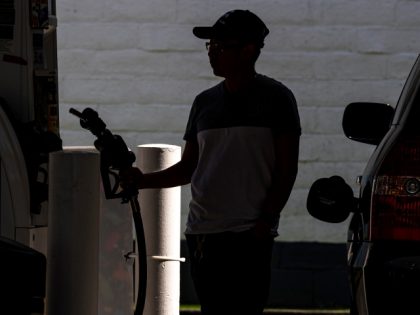 A customer holds a fuel nozzle at a gas station in San Francisco, California, US, on Thurs