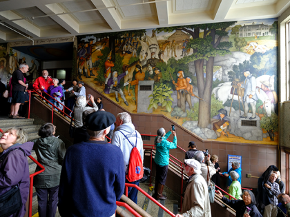 People fill the main entryway of George Washington High School to view the controversial 13-panel, 1,600-square foot mural, the "Life of Washington," during an open house for the public on Aug. 1, 2019, in San Francisco. The San Francisco school board voted Wednesday, June 22, 2022, to rescind a previous …