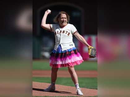 Amy Schneider throws out the ceremonial first pitch before the game between the Los Angele