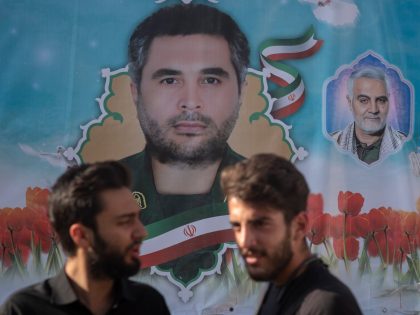 Two Iranian Basiji (Members of Basij Paramilitary force) university students stand under a portraits of the assassinated Islamic Revolutionary Guard Corps Commander, Colonel Sayyad Khodai, and the former Commander of IRGCs Quds Force, General Qasem Soleimani during a rally to mark the thirty-third death anniversary of the Founder of the …