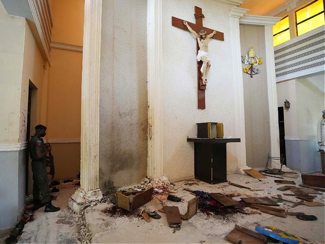 A police officer stands guard inside the St. Francis Catholic Church, a day after an attack that targeted worshipers in Owo, Nigeria, Monday, June 6, 2022. The gunmen who killed 50 people at a Catholic church in southwestern Nigeria opened fire on worshippers both inside and outside the building in …