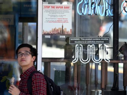 SAN FRANCISCO, CALIFORNIA - JUNE 25: A pedestrian walks by a neon sign advertising Juul e-cigarettes on June 25, 2019 in San Francisco, California. The San Francisco Board of Supervisors voted unanimously, 11-0, to be the first city in the United States to ban e-cigarettes, nicotine pods and devices that …