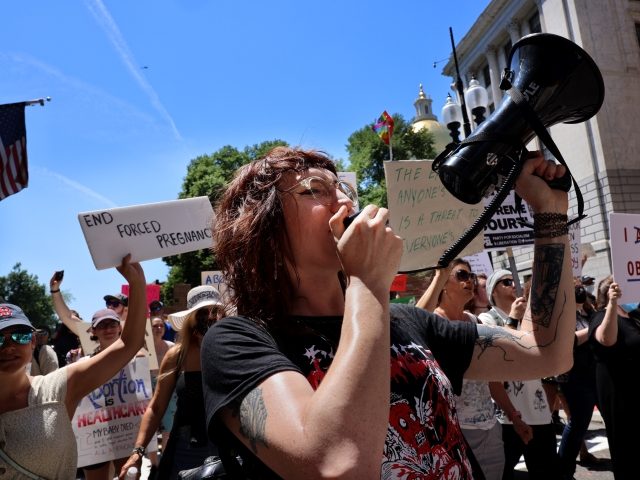 Boston - June 25: Organizer Mandy Wilkens leads a chant as pro-choice demonstrators march