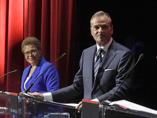 LOS ANGELES, CA - MARCH 22, 2022 - - Los Angeles City Attorney Mike Feuer, right, responds to a pointed accusation made by businessman Rick Caruso as U.S. Rep. Karen Bass observes during the mayoral debate at Bovard Auditorium on the USC campus on March 22, 2022. (Genaro Molina / Los Angeles Times via Getty Images)