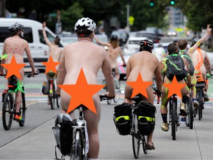 EDS NOTE: NUDITY — Several dozen mostly naked bicyclists ride through Seattle's Capitol Hill neighborhood Sunday, June 28, 2020, some with signs in support of LGBTQ Pride. A Gay Pride march a day earlier came with most LGBTQ Pride weekend events replaced with virtual events because of the coronavirus outbreak. …