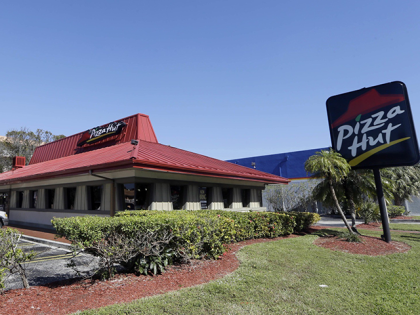 This Jan. 24, 2017, file photo shows a Pizza Hut in Miami. Pizza Hut has reached an agreement with one of its largest franchisees to close 300 underperforming U.S. restaurants. NPC International, a Leawood, Kansas-based franchisee, announced the agreement Monday, Aug. 17, 2020, in a bankruptcy court filing. (AP Photo/Alan …