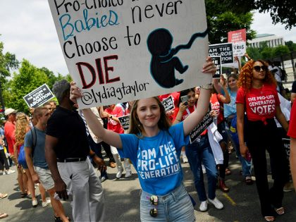 Anti-abortion campaigners celebrate near the US Supreme Court in the streets of Washington, DC, on June 24, 2022. - The US Supreme Court on Friday ended the right to abortion in a seismic ruling that shreds half a century of constitutional protections on one of the most divisive and bitterly …