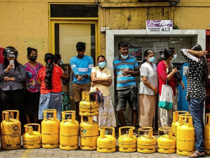 People queue up to buy Liquefied Petroleum Gas (LPG) cylinders in Colombo on June 5, 2022. (Photo by AFP) (Photo by -/AFP via Getty Images)
