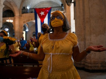A follower of Cuba's patron saint Virgin of Charity prays to the virgin at her church in Havana, on September 8, 2021. (Photo by YAMIL LAGE / AFP) (Photo by YAMIL LAGE/AFP via Getty Images)