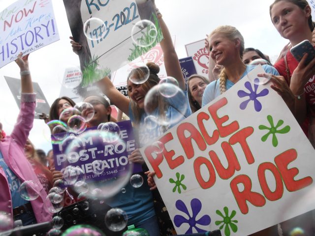 TOPSHOT - Anti-abortion campaigners celebrate outside the US Supreme Court in Washington,