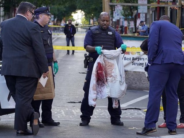 Philadelphia Police investigators work the scene of a fatal overnight shooting on South St