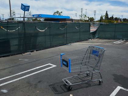A shopping cart outside a Walmart gas station under construction in Lakewood, California, US, on Sunday, May 15, 2022. Walmart Inc. is scheduled to release earnings figures on May 17. Photographer: Bing Guan/Bloomberg via Getty Images
