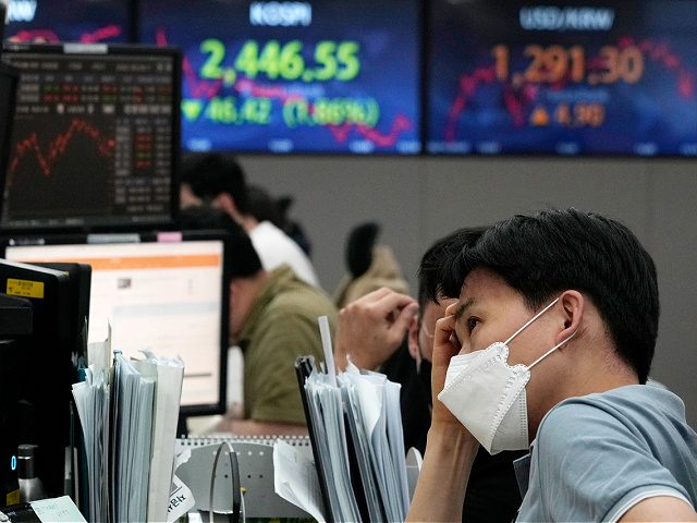 A currency trader watches monitors at the foreign exchange dealing room of the KEB Hana Bank headquarters in Seoul, South Korea, Wednesday, June 15, 2022. Asian stock markets were mixed Wednesday ahead of the Federal Reserve's announcement of how sharply it will raise interest rates to cool U.S. inflation. (AP …