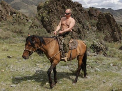 Then Russian Prime Minister Vladimir Putin rides a horse while traveling in the mountains