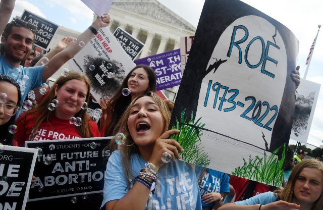 Anti-abortion campaigners celebrate outside the US Supreme Court in Washington, DC, on Jun