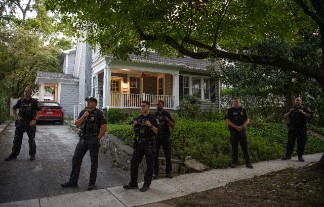 Police stand guard as abortion rights activists protest near the house of US Supreme Court