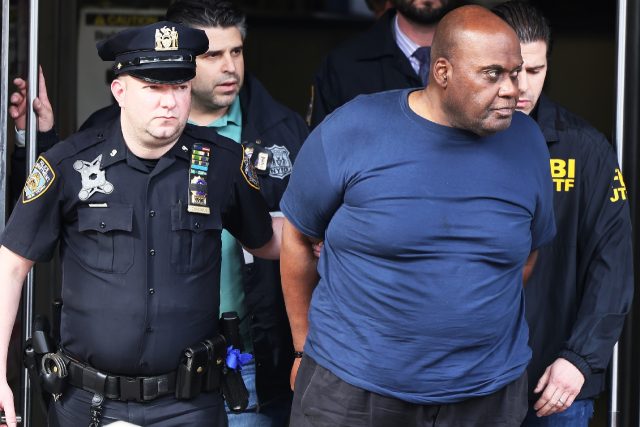 Suspect Frank James is escorted out of a police precinct after being arrested for a New Yo